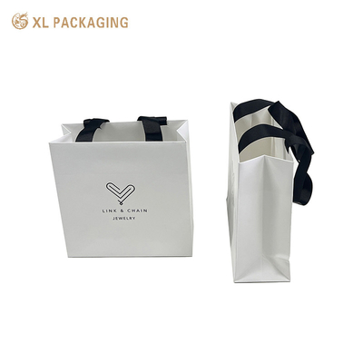 kopen Op maat gemaakte luxe drukpapier zak geschenkpapier verpakkingspapier zak met het aangepaste logo stof pakket verzendzak online manufacture