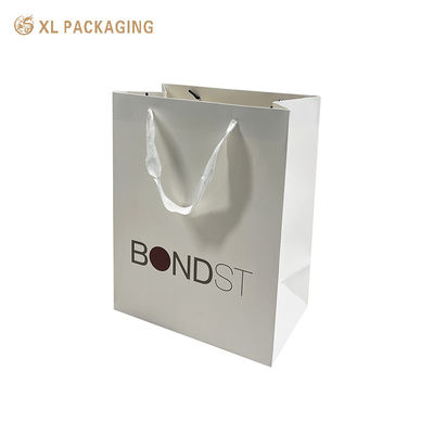 kopen Premium 250 gram dik kunstpapier winkeltasjes met witte lint handgrepen en aangepaste CMYK-druk voor luxe cadeauverpakkingen online vervaardiging
