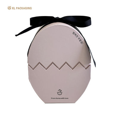 Luxe roze eivormige chocolade papieren cadeau dozen met lint.